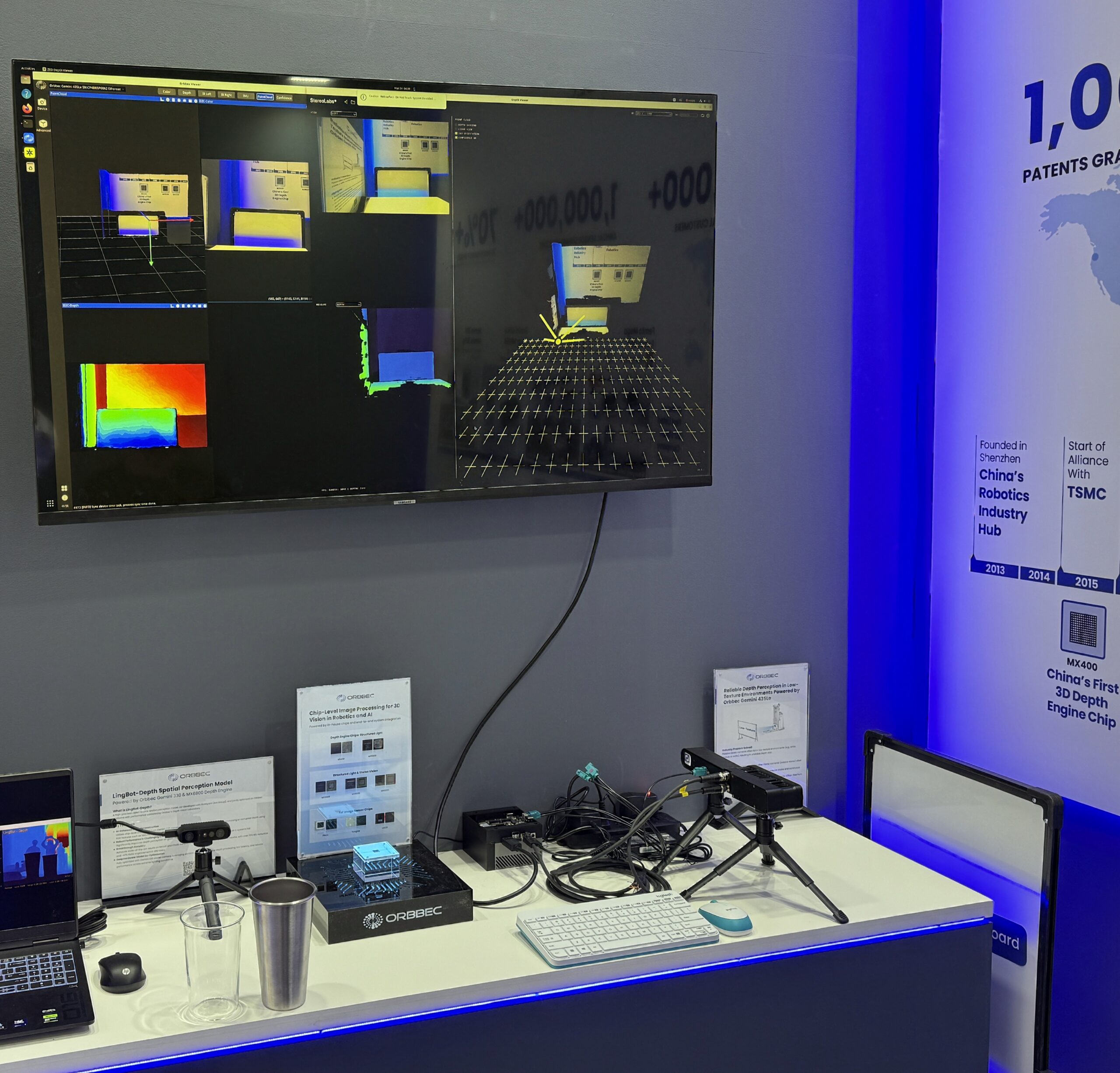 Orbbec booth demo at LogiMAT 2026 showing LingBot-Depth spatial perception AI model and chip-level image processing display with depth visualization on monitor