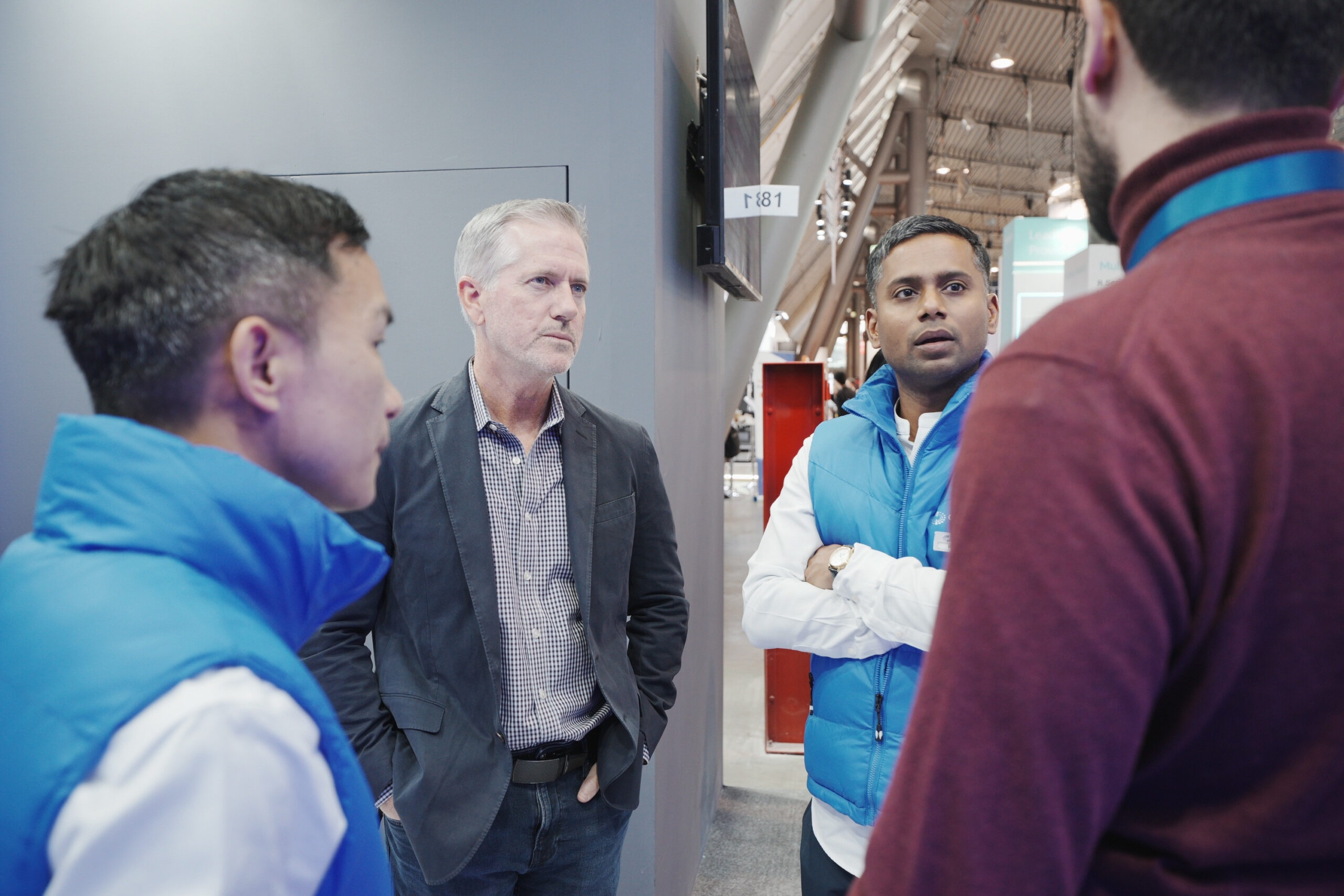 Orbbec team members engaging in technical consultation with a visitor at the Orbbec booth during LogiMAT 2026