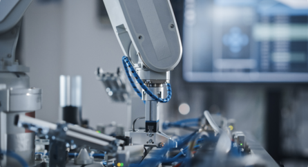 Robotic arm with integrated depth camera performing pick-and-place operation in manufacturing